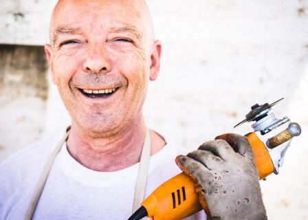 Picture of handyman with construction saw